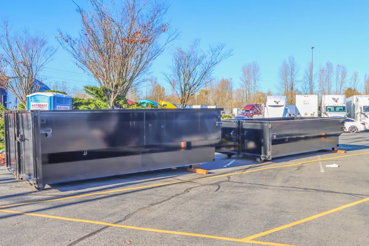 Professional dumpster rental service with roll-off container on residential driveway in Upper St. Clair